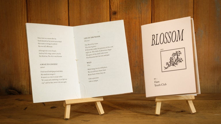A book on a stand showing Festival of Blossom poetry by Ham Youth Club on display at Ham House London